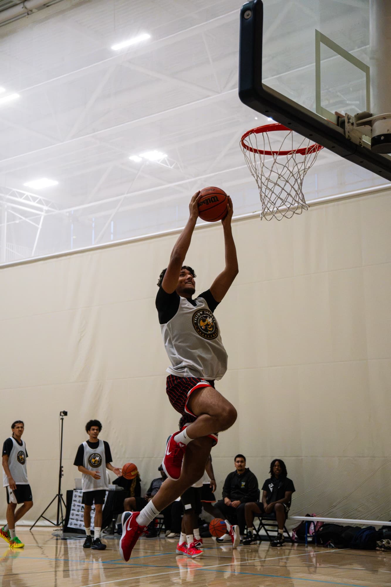 A Yellowjackets player rising for a dunk