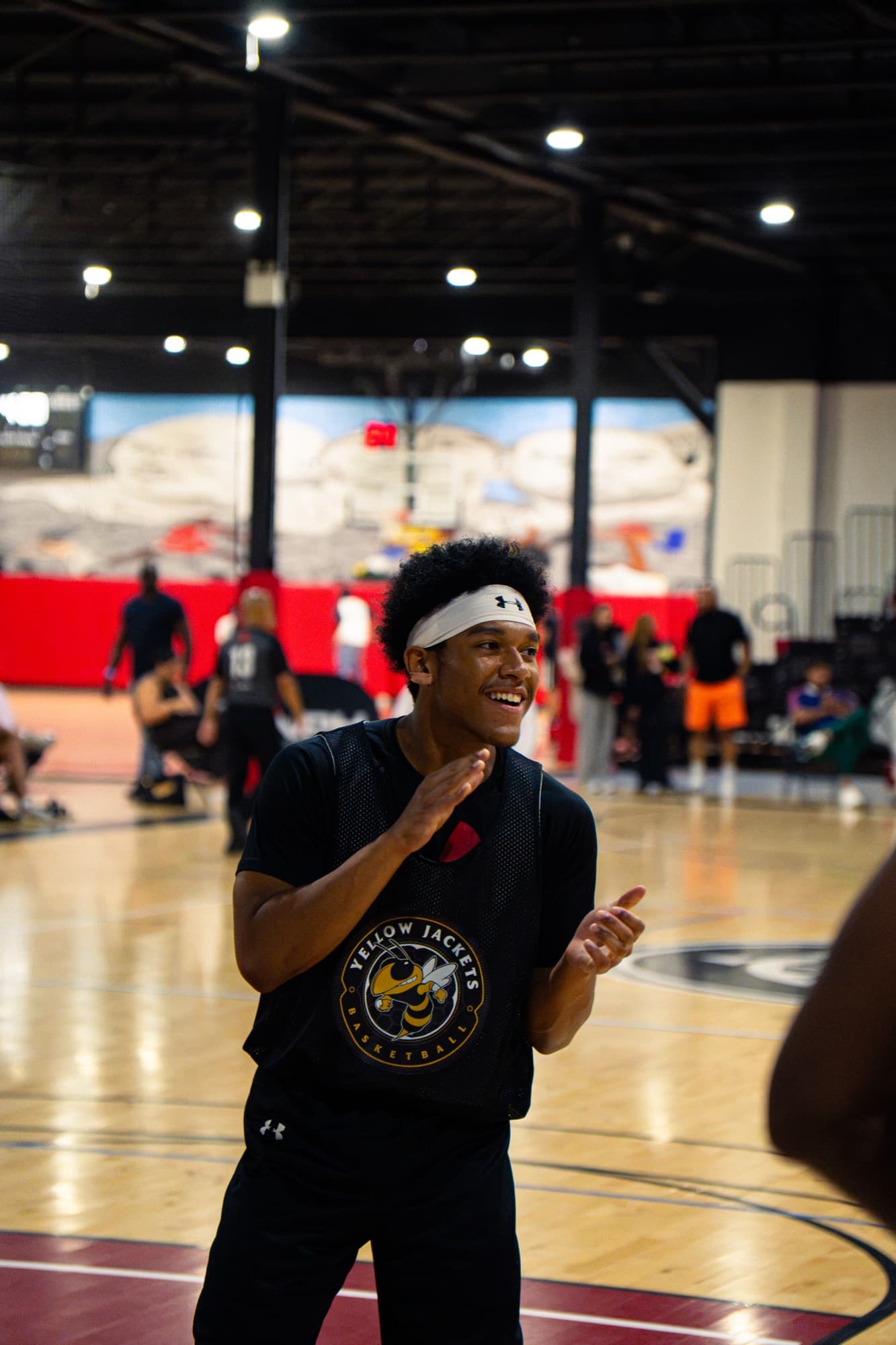 A Yellowjackets player smiling during warm-ups