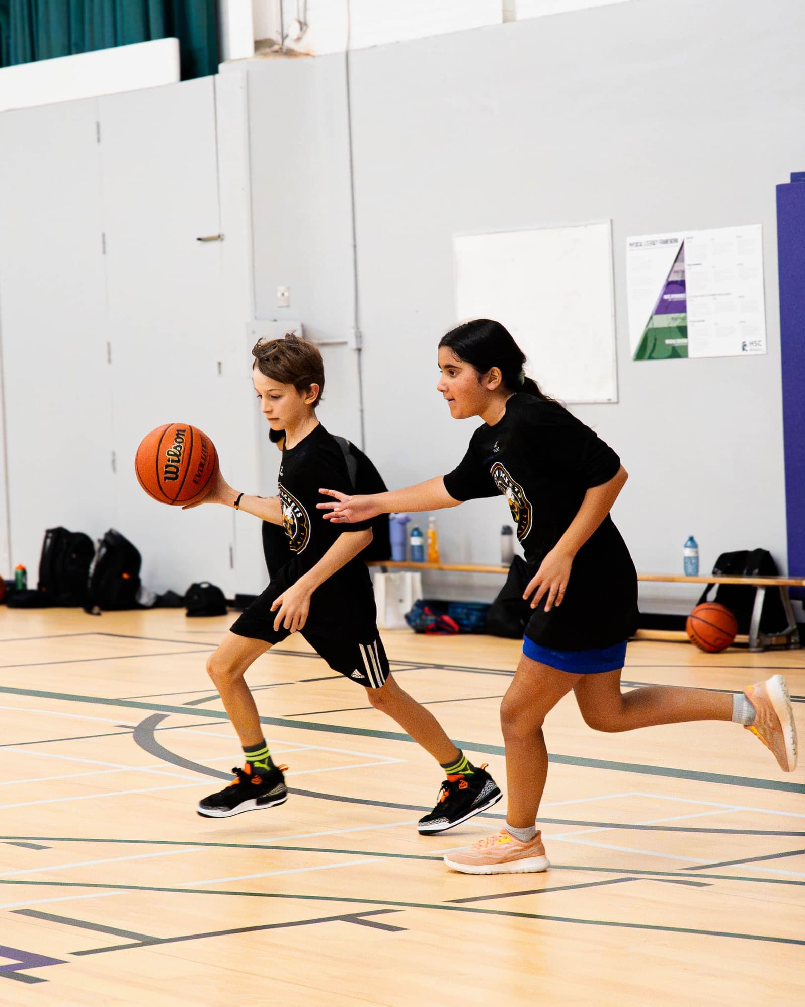 A camper driving up the floor with the ball